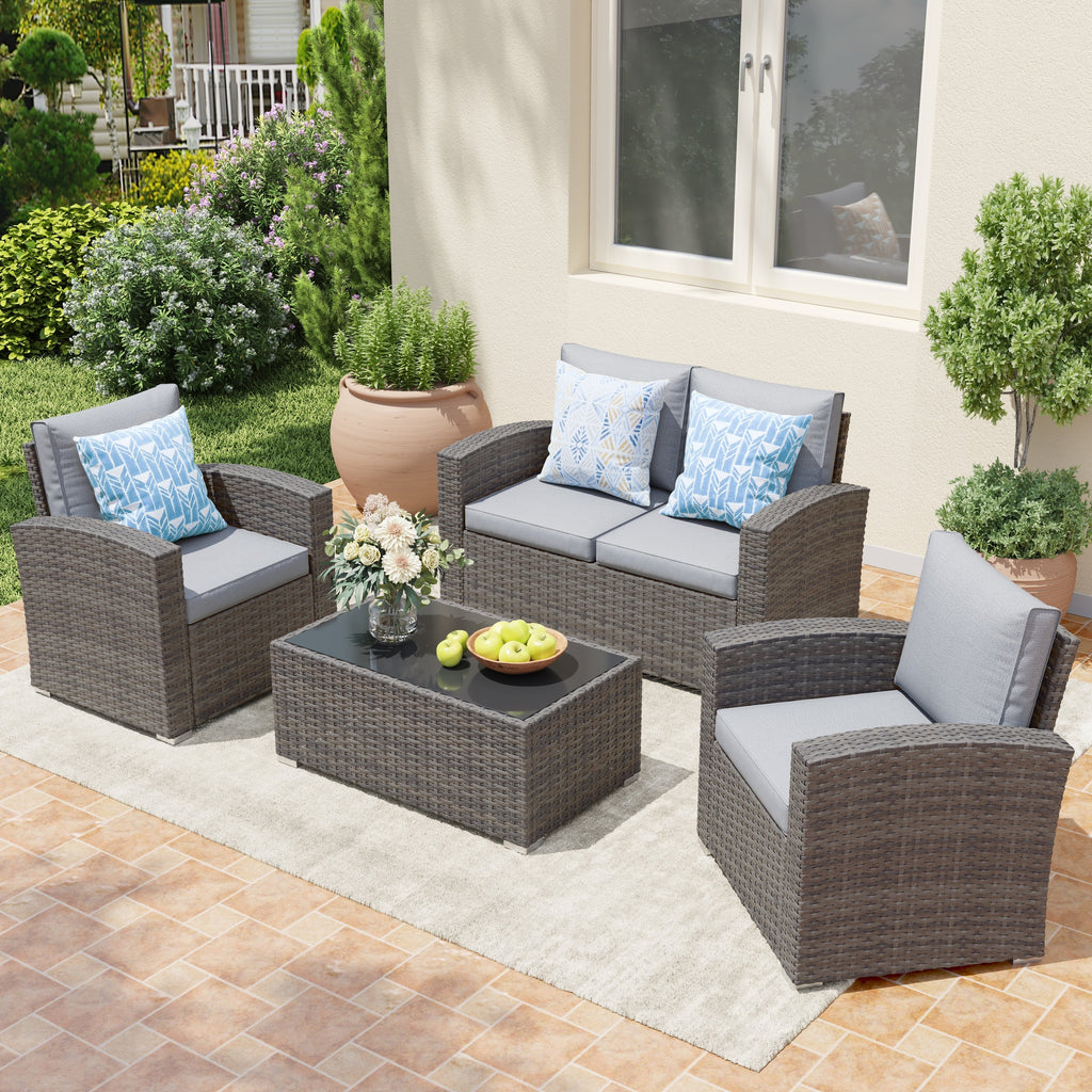 Salon de jardin en rotin pour 4 personnes avec coussins gris et table en verre trempé