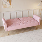 Un canapé-lit de 176 cm de long recouvert de velours, orné d'une bordure cloutée et accompagné d'un coussin assorti.