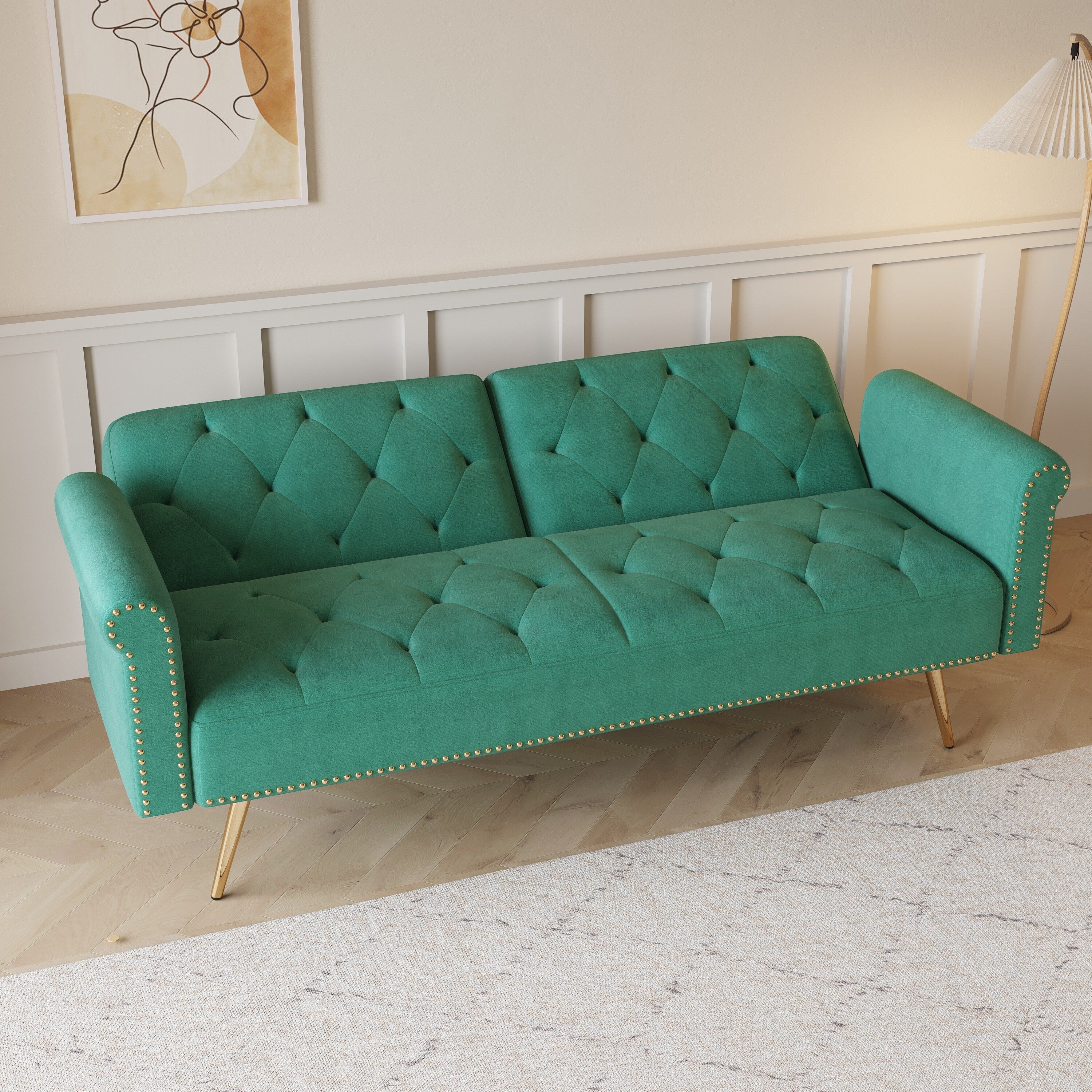 Un canapé-lit de 176 cm de long recouvert de velours, orné d'une bordure cloutée et accompagné d'un coussin assorti.