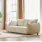 Canapé 3 places en chenille beige avec coussins supplémentaires