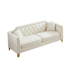 Canapé 3 places capitonné en chenille beige avec décoration cloutée en cuivre