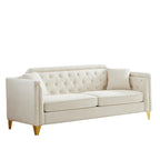 Canapé 3 places capitonné en chenille beige avec décoration cloutée en cuivre