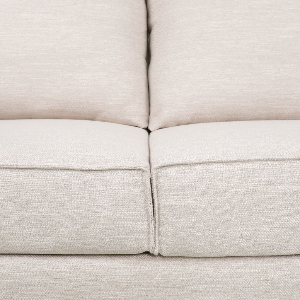 Canapé 3 places beige rembourré avec coussins et pieds en bois