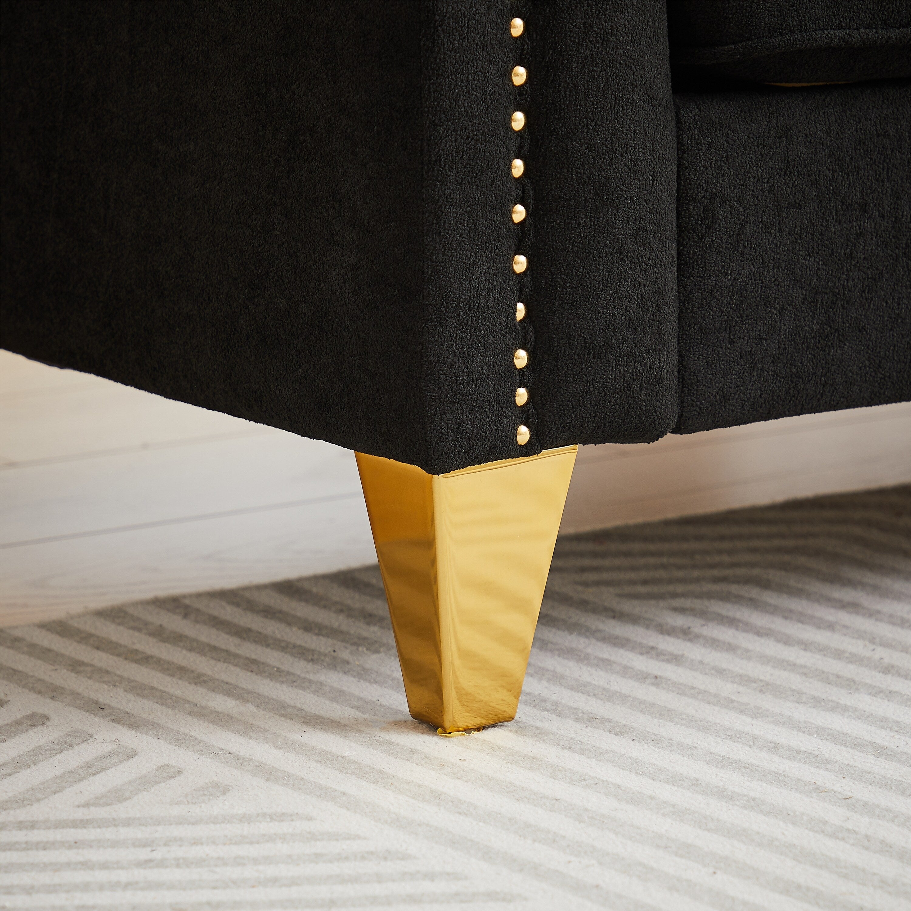 Canapé capitonné 3 places en chenille noire avec décoration cloutée en cuivre